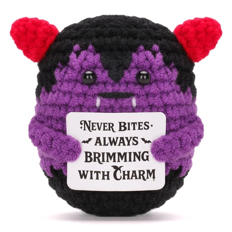 A handmade crochet animal doll with black and purple fur and red ears, featuring a card that reads Never Bites Always Brimmin