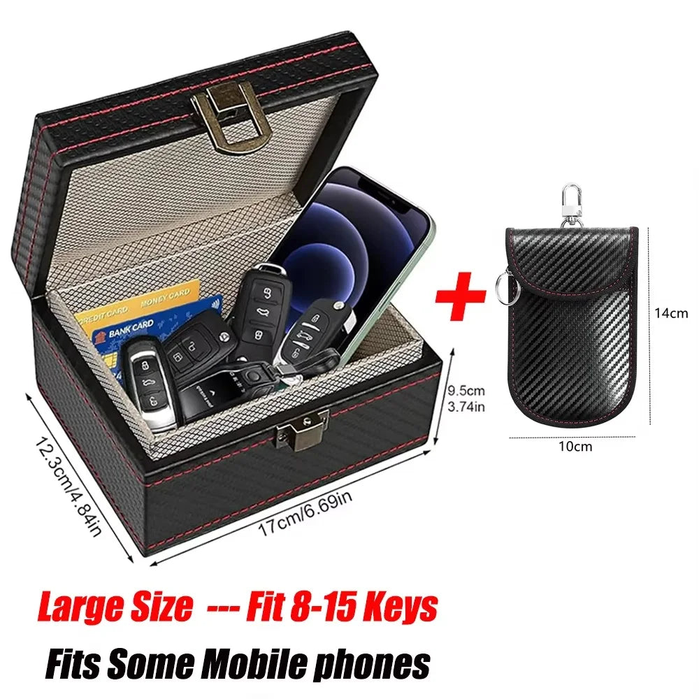 A black carbon fiber box with a lid open, displaying slots for keys and mobile phones.