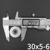 Countersunk neodymium disc magnets with a center hole shown next to a digital caliper.