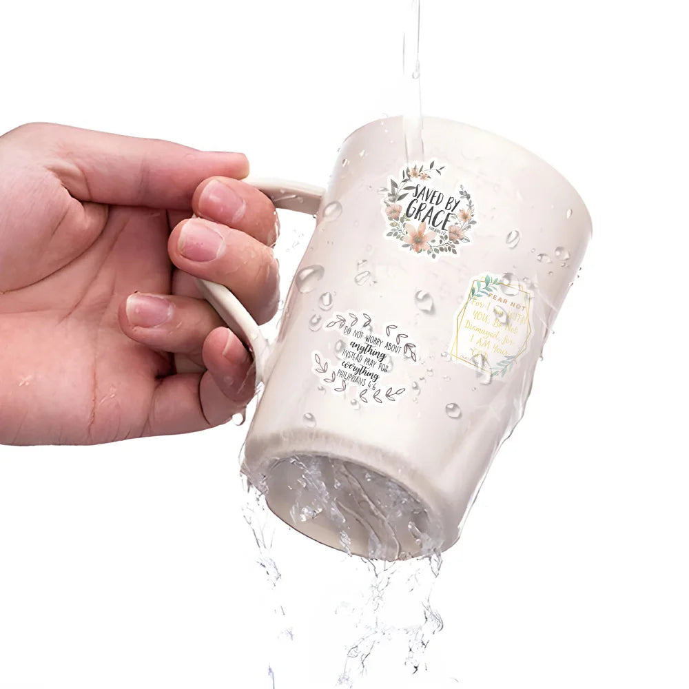 A hand is pouring water into a ceramic mug decorated with an inspirational Bible verse sticker.