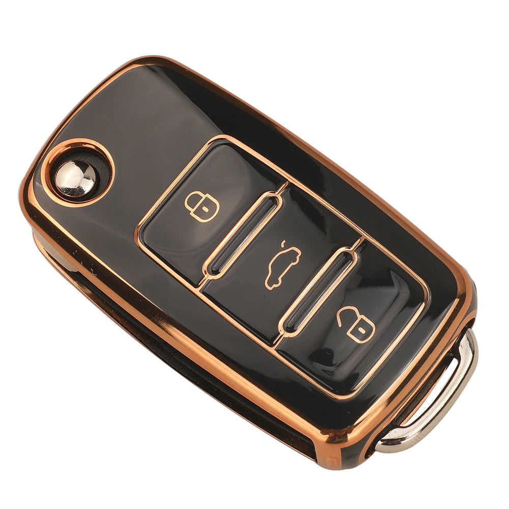 A black TPU silicone car key case with a gold-colored finish, showing multiple key cutouts.