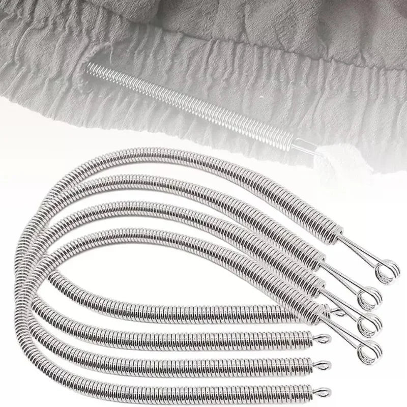 A close-up view of a silver spring drawstring needle threader tool with multiple coiled ends.