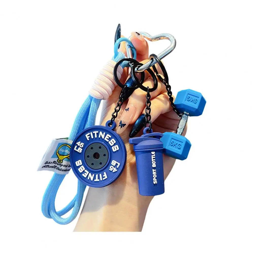 A hand holds a fitness keychain featuring a blue and black charm with a sports bottle attached.