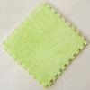 A square piece of bright lime green soft plush interlocking floor tile.