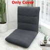 A dark gray foldable floor sofa cover for a single seat or lounger placed on a white floor.