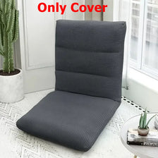 A dark gray foldable floor sofa cover for a single seat or lounger placed on a white floor.