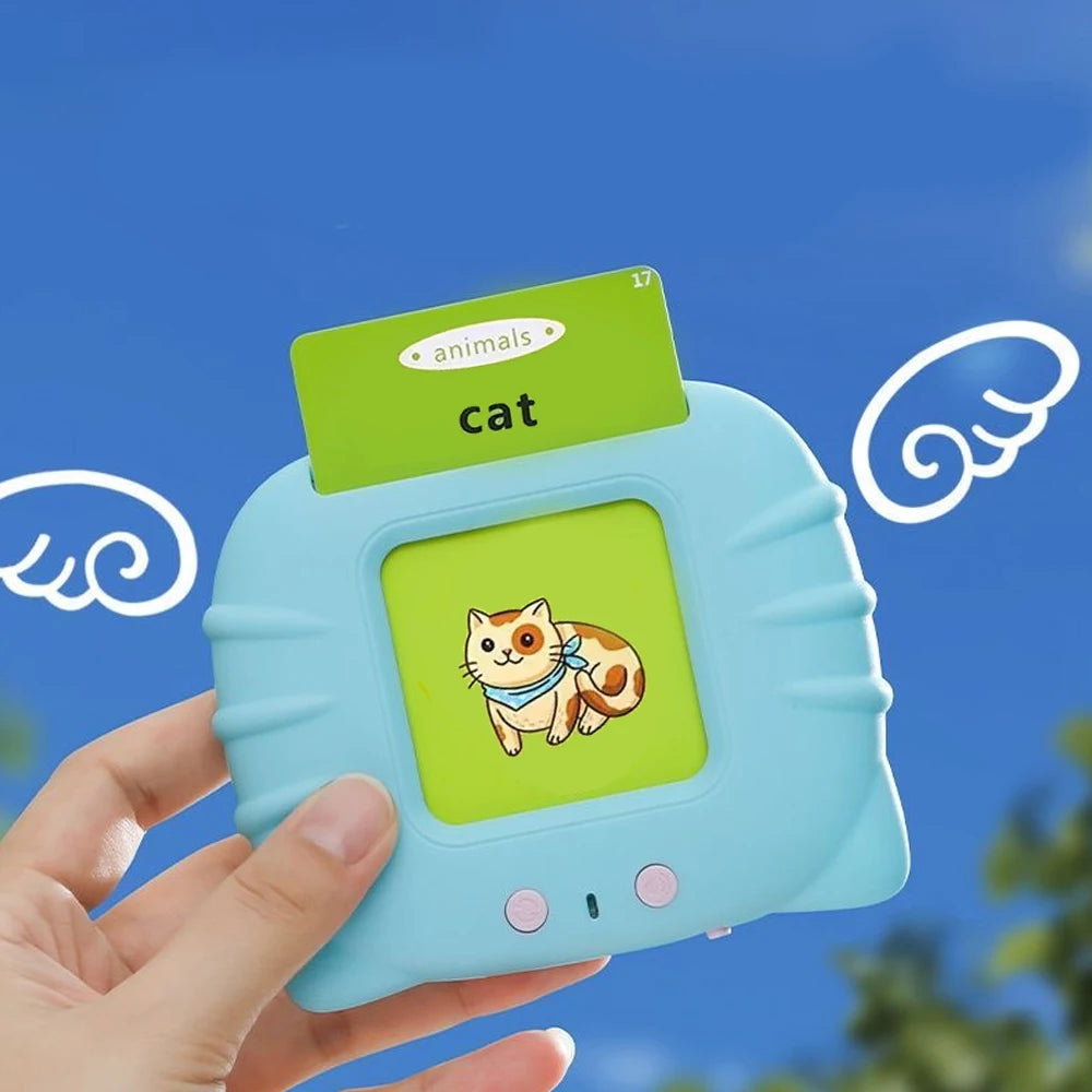 A hand holds a light blue learning toy featuring a cat illustration and a green card labeled cat.