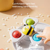 A hand is pressing a colorful silicone bath toy on a plate to make a sound for stress relief.