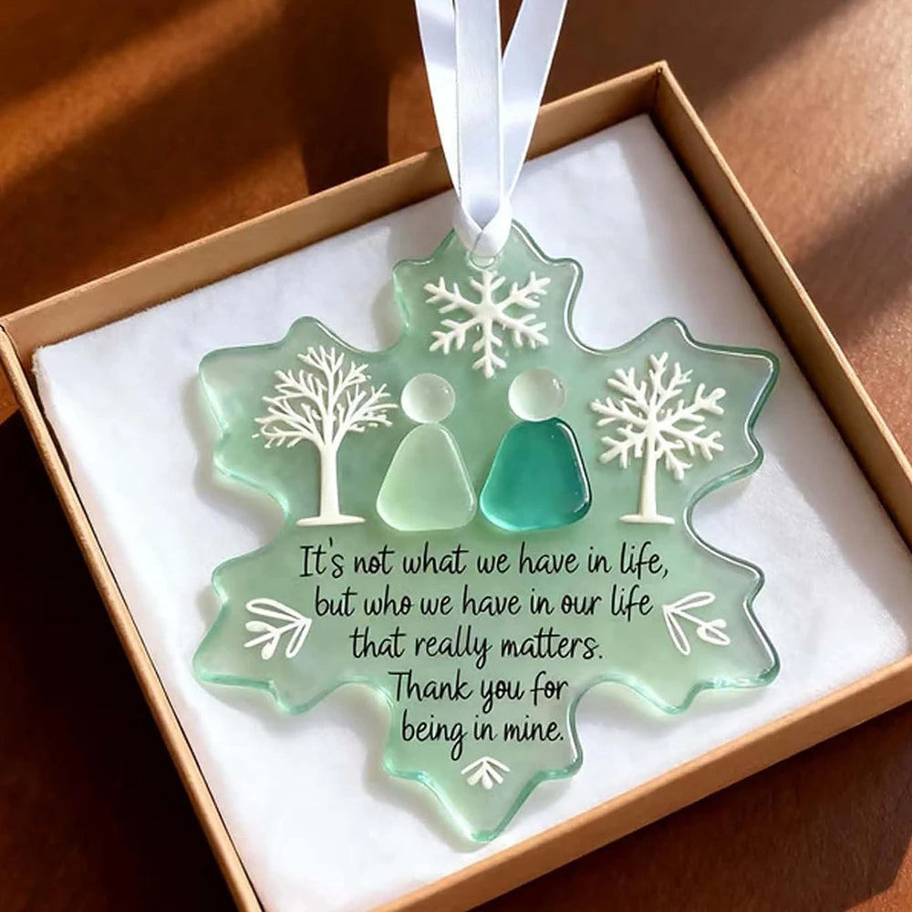 A handcrafted sea glass ornament shaped like a snowflake, featuring silhouettes of two people and a message of appreciation.