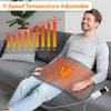 A man is using a 9-speed temperature adjustable electric heating pad on his lap while sitting on a sofa.