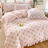 Pink floral ruffle cotton duvet cover set with white piping and decorative pillows