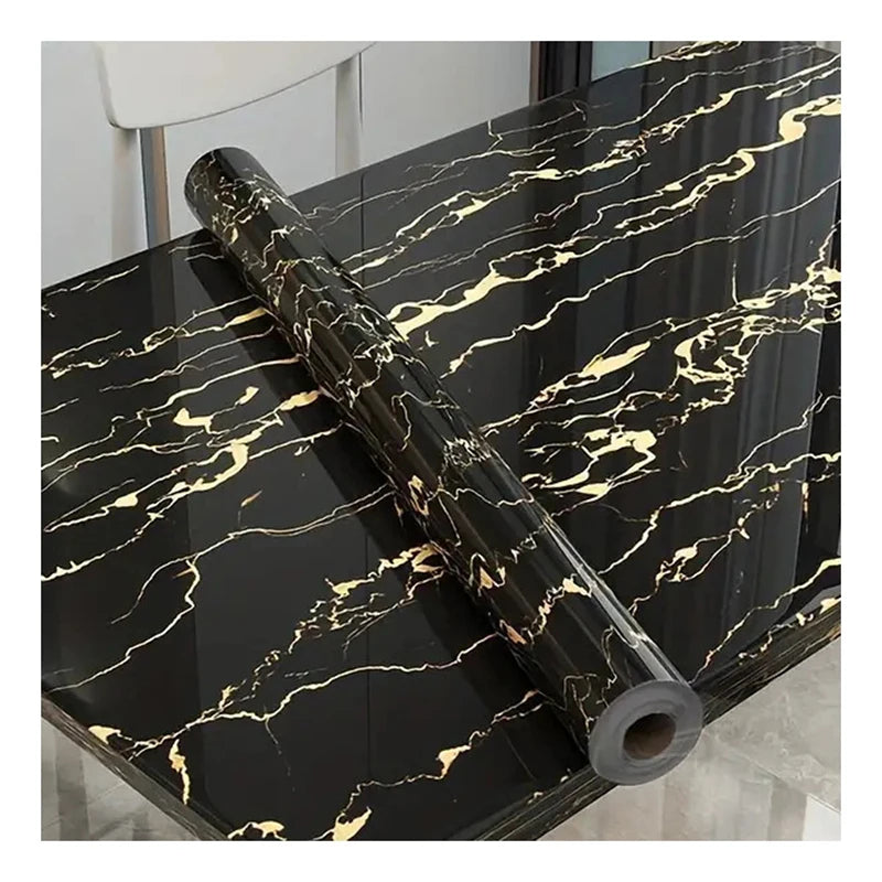 A black marble roll self-adhesive wall sticker with gold veining displayed on a dark surface.