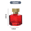 A clear glass perfume bottle with a red liquid and a gold cap, shown next to a measurement scale.