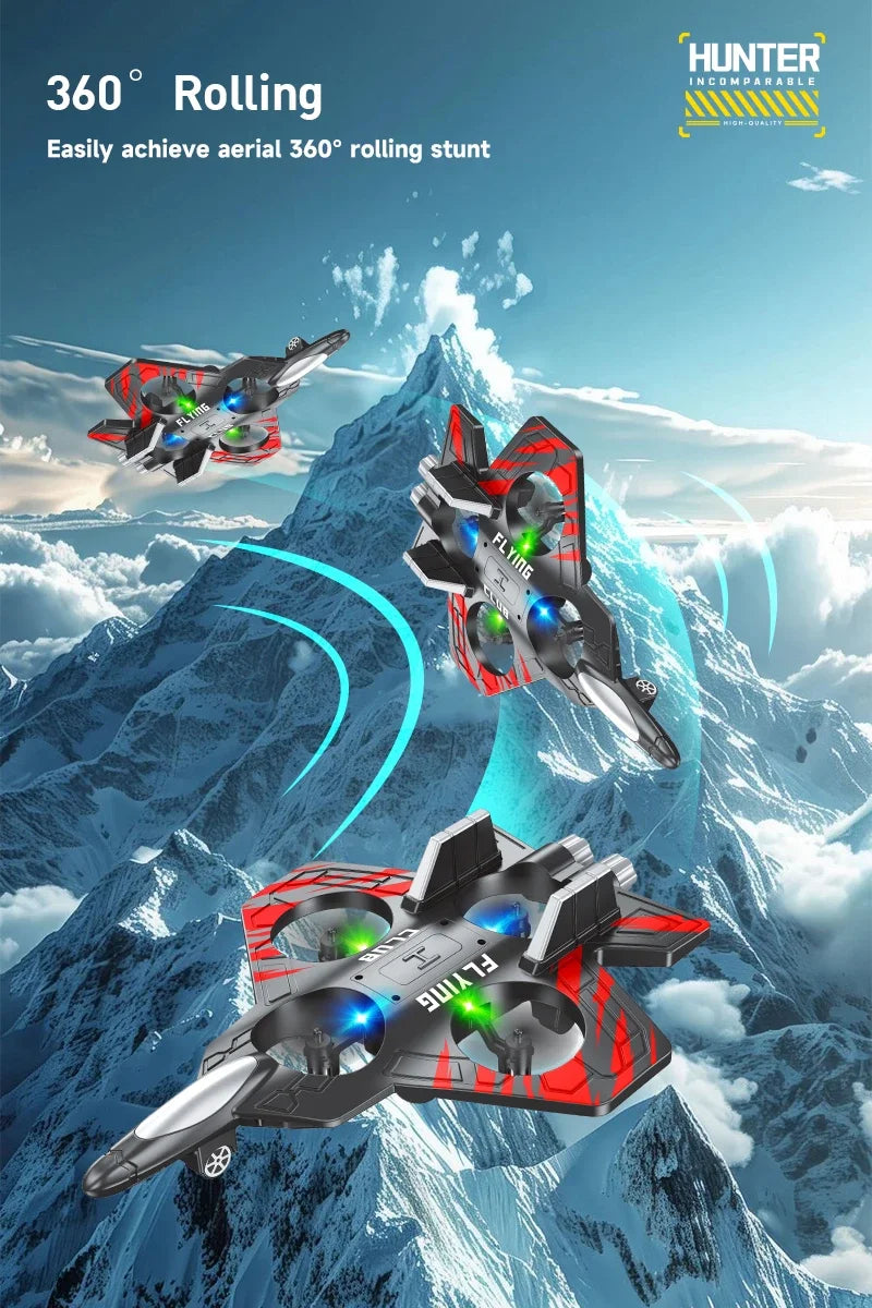 A red and black EPP foam RC stunt glider airplane performing a 360 degree rolling stunt against a snowy mountain backdrop.