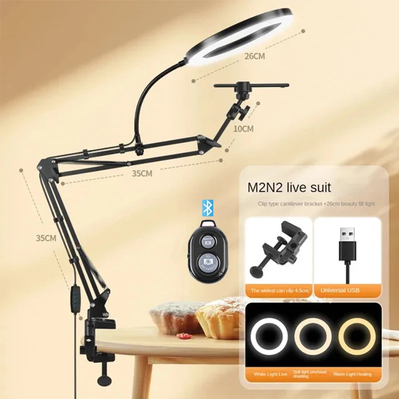 Black adjustable phone stand with an overhead light illuminating a food item on a wooden table.