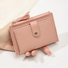 A light pink women's slim PU leather card holder wallet is held in a hand against a white background.