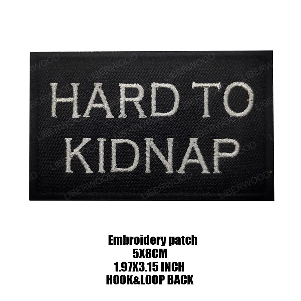 Black embroidered patch with the text HARD TO KIDNAP in white thread