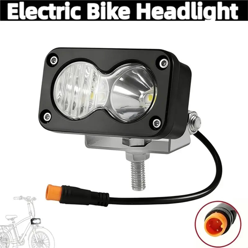 A black electric bike headlight with a clear lens and wire connector.