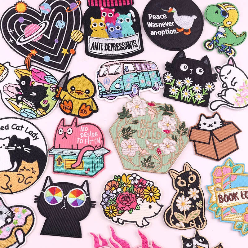 A collection of cartoon cat embroidery patches featuring various cats in different styles and colors.