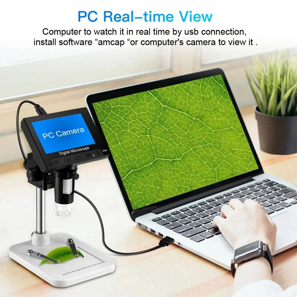 A laptop displays a live feed from a PC camera connected to a digital microscope for real-time viewing.