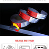Roll of red and white reflective safety tape being used for vehicle decoration or marking.