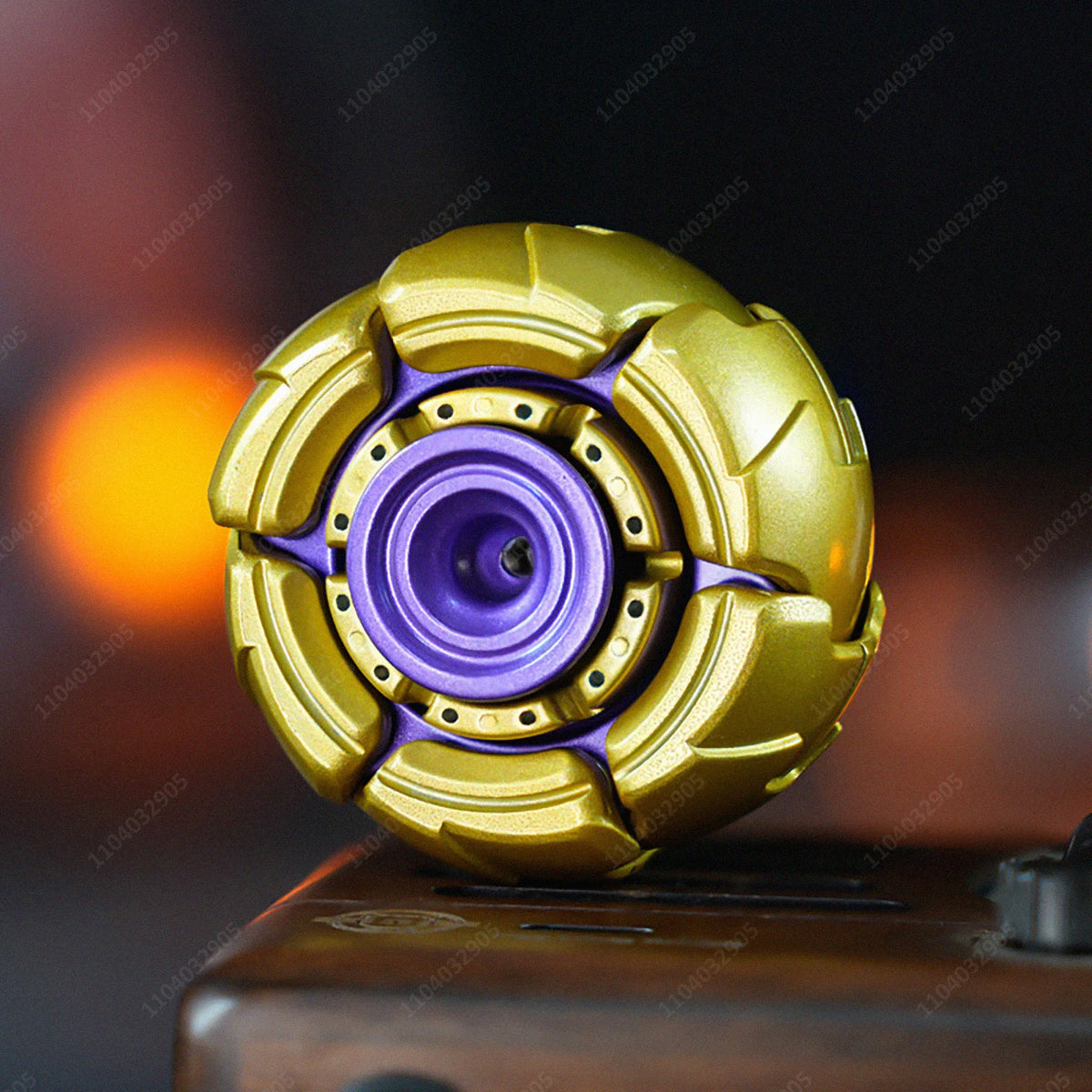 A close-up shot of a gold and purple fidget spinner resting on a dark wooden surface.