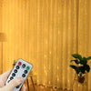 A hand holds a smartphone displaying the control interface for USB LED curtain lights with remote, set against a bright yello