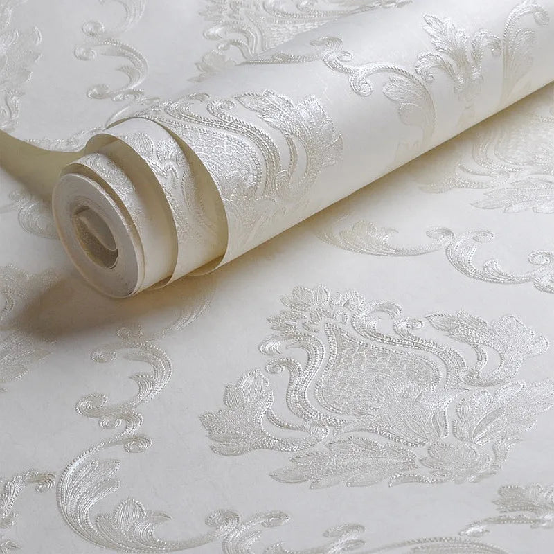Roll of white embossed damask wallpaper featuring a textured floral design.