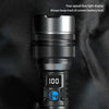 A close-up view of a black flashlight with a digital LCD display showing 100% battery level.