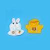 A white rabbit plush toy and a yellow hoodie with gold chain details.