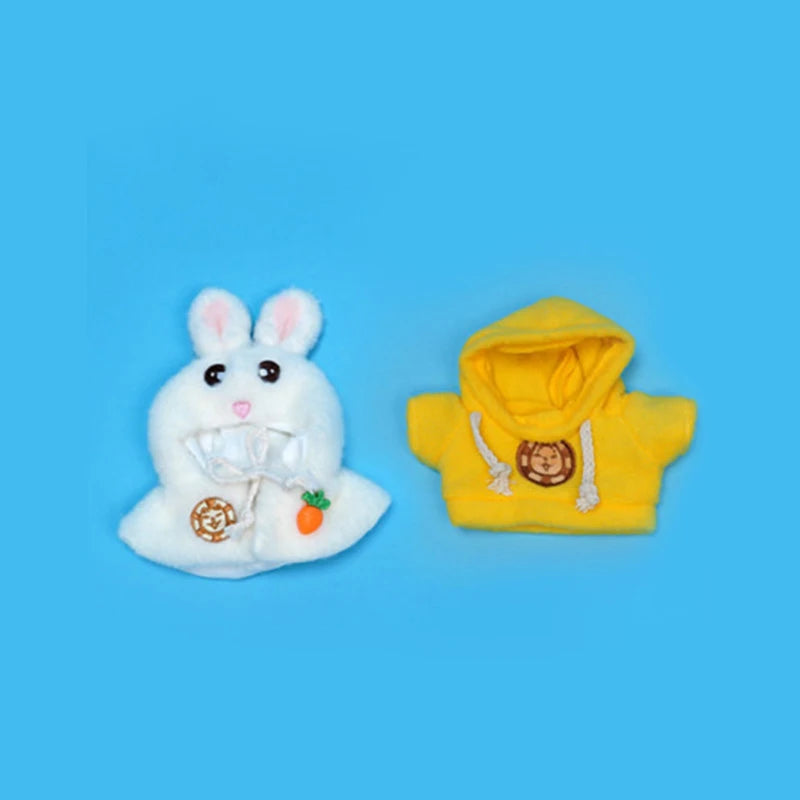 A white rabbit plush toy and a yellow hoodie with gold chain details.