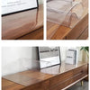 Clear PVC waterproof table protector used to cover and protect wooden furniture surfaces.