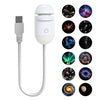 A white 2-in-1 mini galaxy star projector night light with a USB connector and multiple colorful star patterns.
