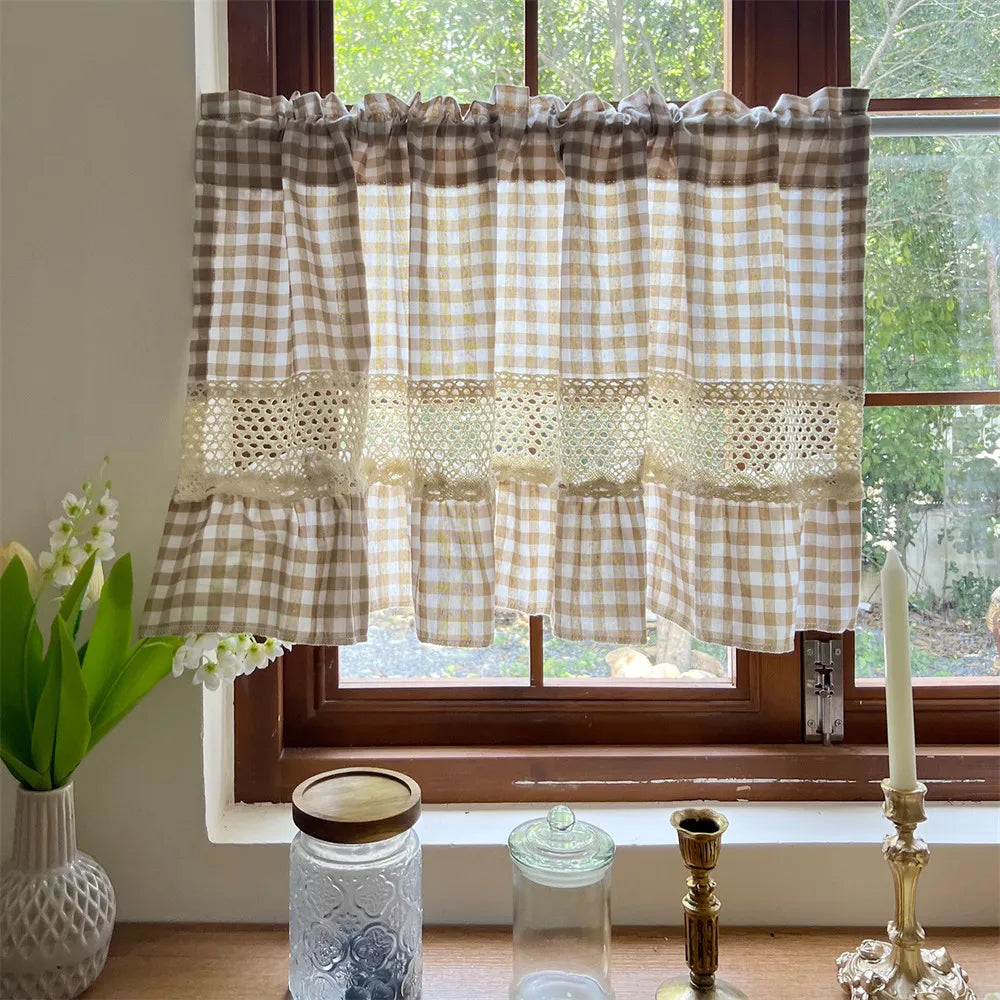 Beige gingham cafe curtain with crochet lace trim hanging in a window.