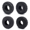 A set of black rubber mud terrain tires for Axial SCX24 and TRX4M, shown from various angles.