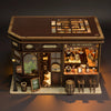 A detailed wooden dollhouse miniature assembly kit featuring a facade with glass windows and interior details.