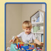 A young child is playing with a blue and green interactive racing rail car set featuring various vehicle designs.