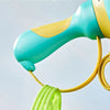 A close-up of a teal and yellow pull-string flying saucer toy launcher with a green string visible.