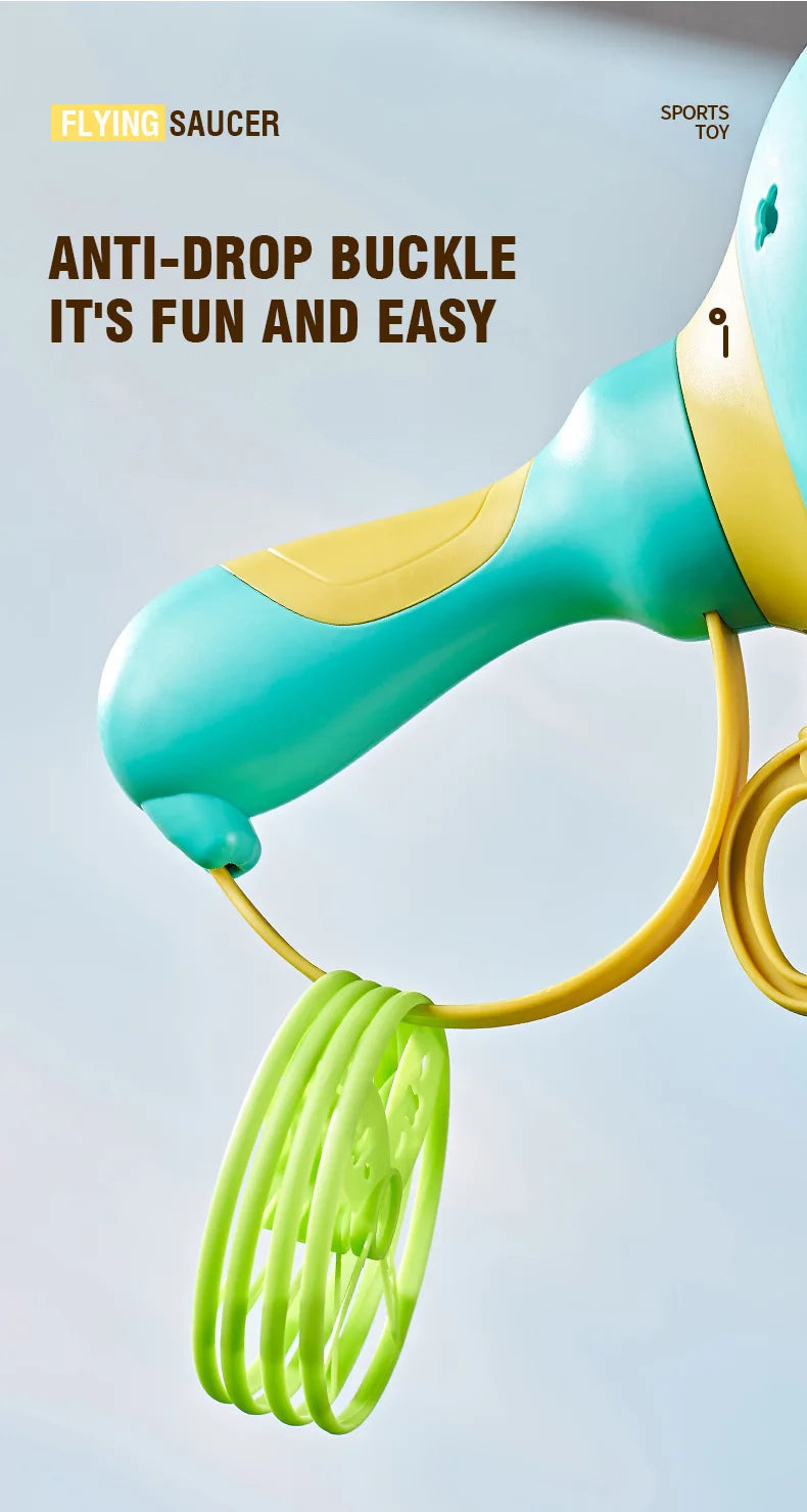 A close-up of a teal and yellow pull-string flying saucer toy launcher with a green string visible.