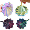 A hand holds a colorful 3D illusion fidget star toy with swirling spiral patterns.
