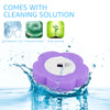 A purple disposable toilet brush set with a white sponge head is shown submerged in water.