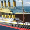 A detailed model kit of a large ship, resembling the Titanic, built from interlocking plastic blocks.