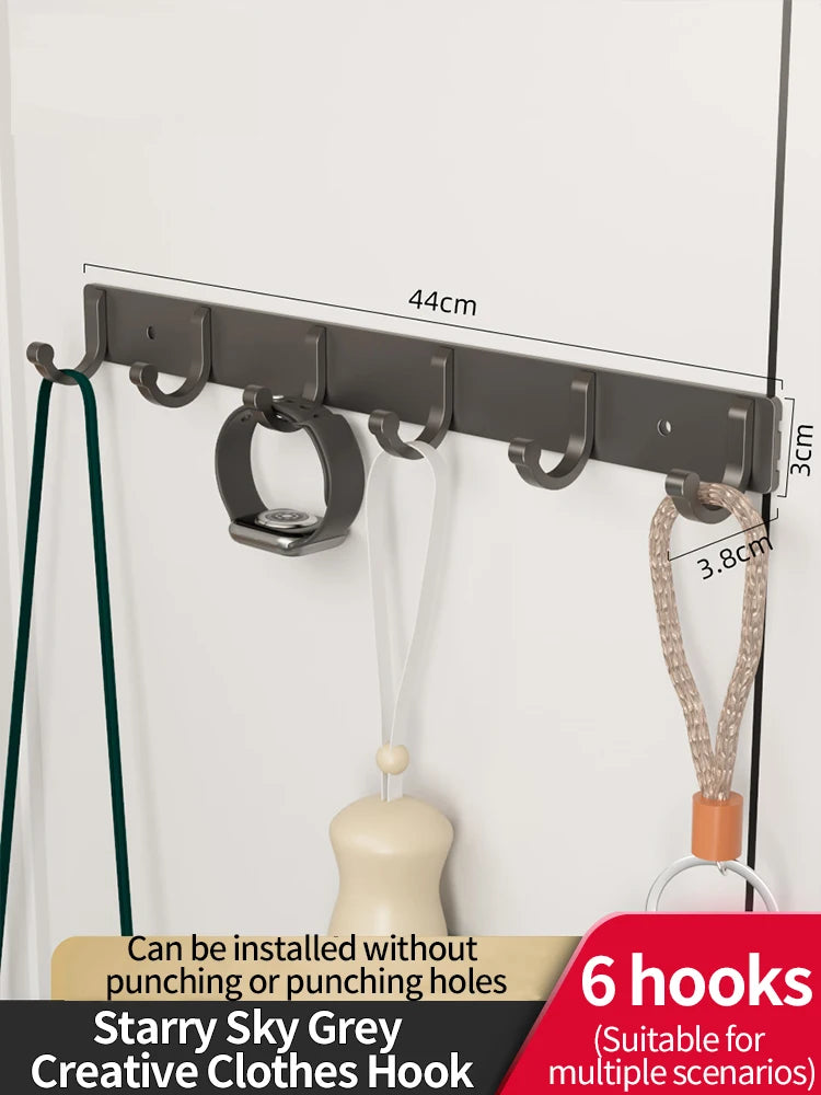 A set of six grey wall hooks with adhesive backing is shown mounted on a white surface.