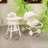 A white fashion doll accessories set featuring a wooden high chair and a baby carrier/pram.