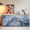 A kitchen backsplash featuring blue marble with gold veining and horizontal stripes.