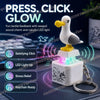 A white seagull-shaped fidget toy keychain with an LED light, displayed on a dark surface.