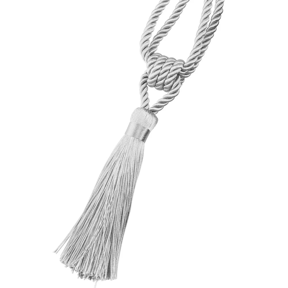 A silver braided rope with a tassel used as an elegant curtain tieback.