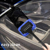 A black car windshield is being cleaned with a blue microfiber squeegee wiper tool.