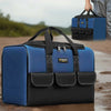 A blue and black heavy duty tool bag with reinforced base and multiple pockets is shown in an outdoor setting.