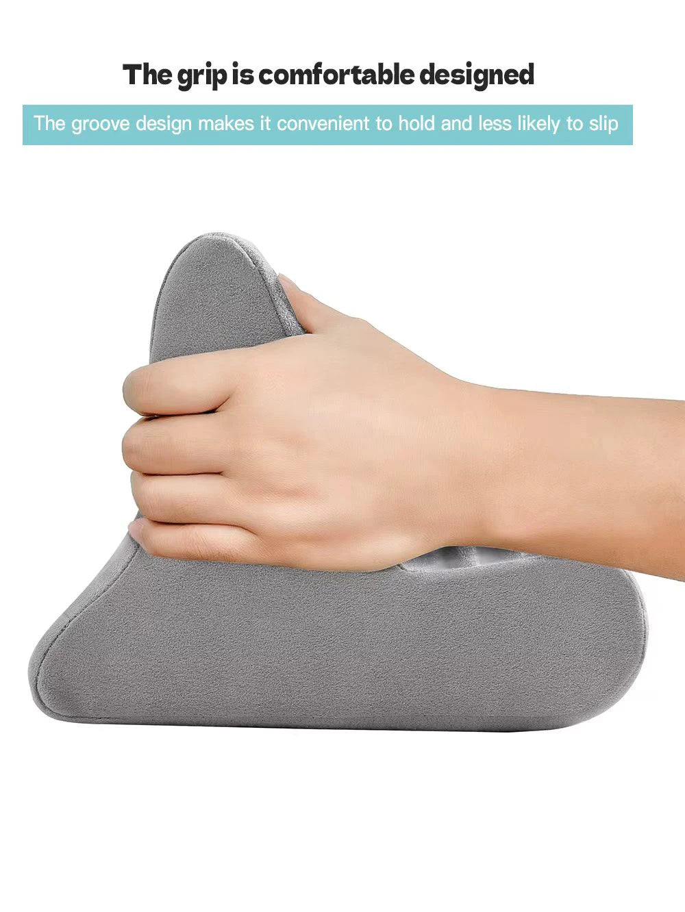 A hand is holding a gray, contoured pillow designed as a grip for an adjustable comfort tablet and phone stand.
